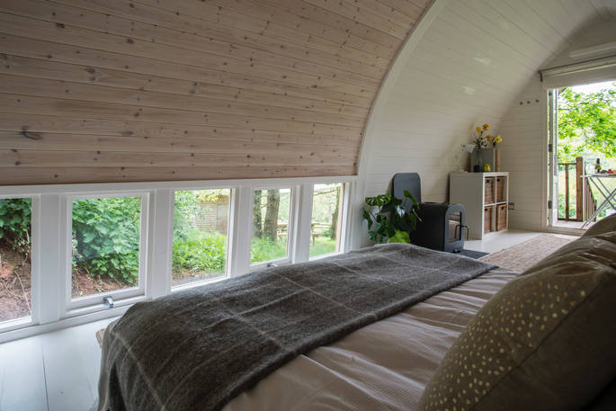 The wood clad bedroom walls from the bed at Fleur's Retreat in Devon