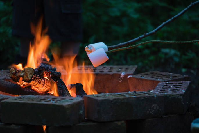 Toasting marshmallows on the fire pit at Fleur's Retreat in Devon