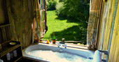 Sit back and relax in the bath tub with a glass of champagne watching the Devon sky at Orchard Wagon
