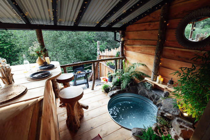 Ursabear cabin blacony with outdoor steel bath, Morebath, near Bampton, Mid Devon