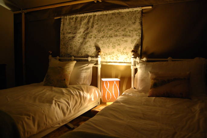 A set of warm twin beds at Taw safari tent in Devon