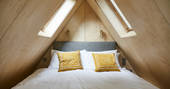 Super king-size bed on mezzanine level inside Cleave Treehouse at Windout Farm in Devon