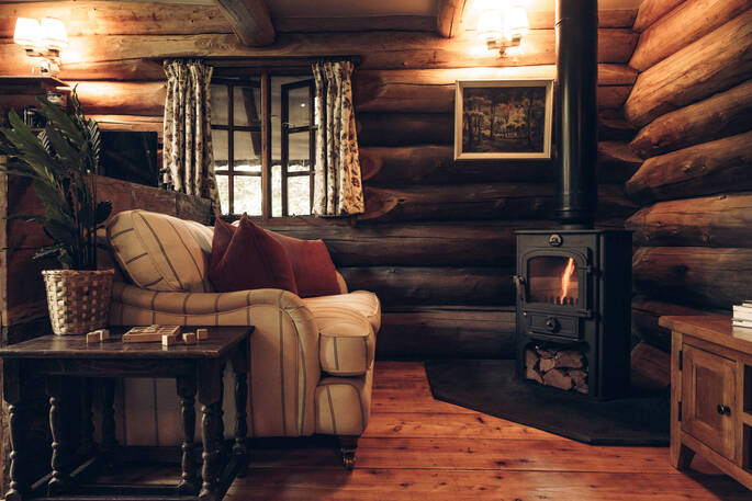 Living area with a sofa and wood burner