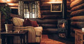 Living area with a sofa and wood burner