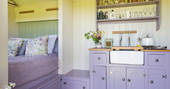  King size bed inside The Happy Hare with fully equipped kitchen at Colber Farm in Dorset