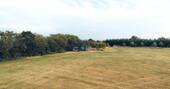 13 - Hut is located on the edge of a large field