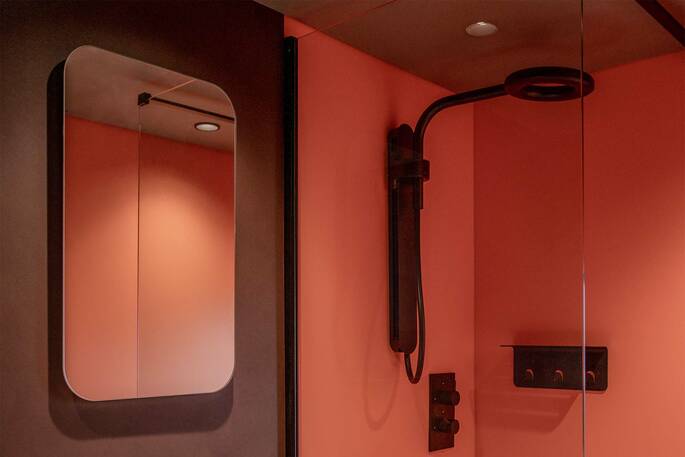 Bathroom with a hot shower, sink and flushing toilet