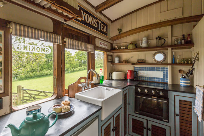 Fully equipped kitchen with a plate of delicious scones on the counter at Camping Coach in Dorset