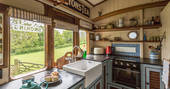 Fully equipped kitchen with a plate of delicious scones on the counter at Camping Coach in Dorset