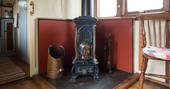 Gorgeous antique wood burner inside Camping Coach train carriage