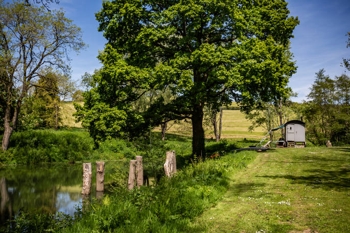 A sunny day by the river at Laverstock's Everdene Hut in Dorset