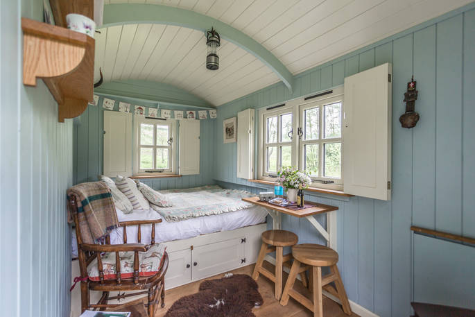 Relax in the comfortable double bed at Laverstock's Everdene Hut after a long day of exploring