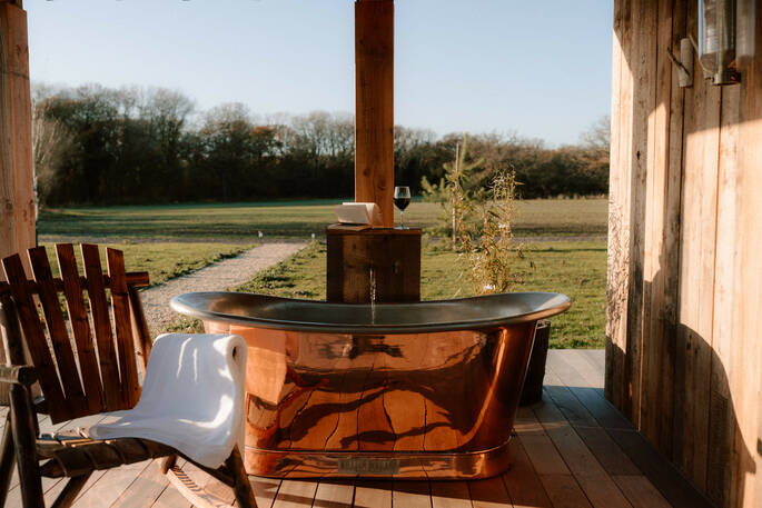 Outdoor bath tub showing path to cabin