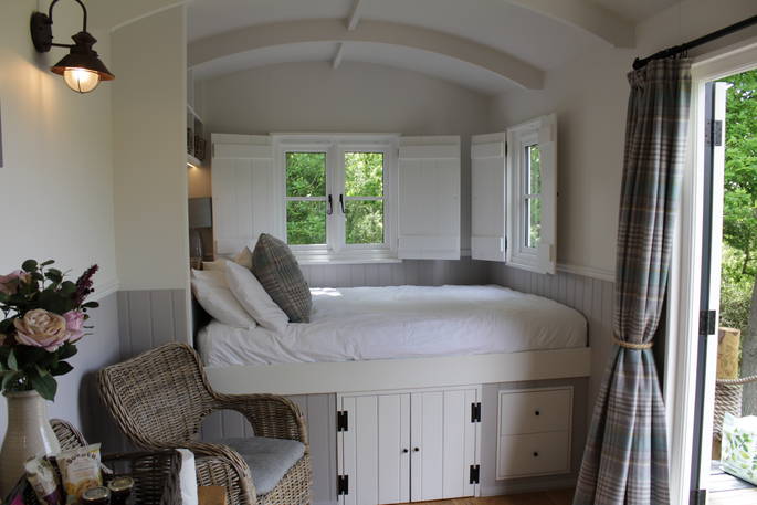 King-size bed at the back of Teal at The Shepherds Hide in Essex 