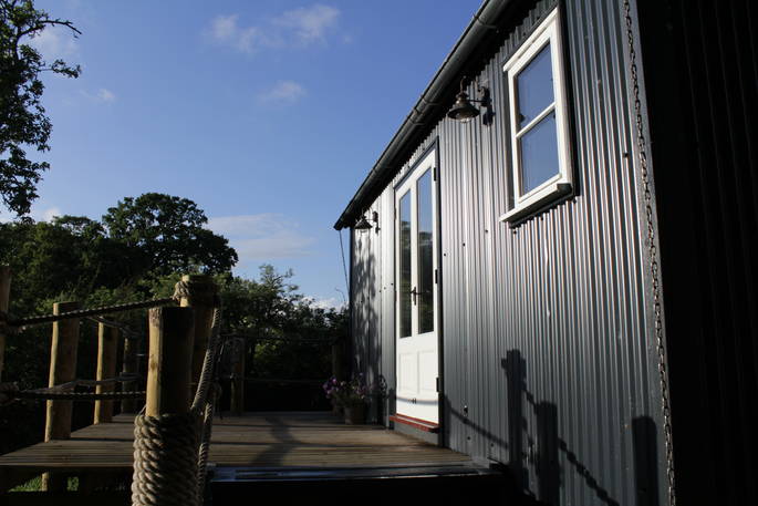 Steps leading up to the decking to Teal at The Shepherds Hide in Essex