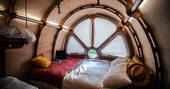 Double bed set up inside The Fuselage cabin at Lypiatt Hill in the Cotswolds