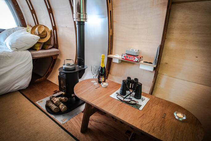 Light the wood-burner and enjoy a glass of bubbles inside The Fuselage at Lypiatt Hill in Gloucestershire 