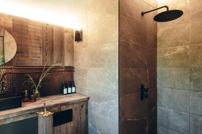 Bathroom with a hot shower, sink and flushing toilet