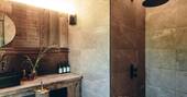 Bathroom with a hot shower, sink and flushing toilet