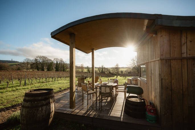 Covered area outside with dining area and pizza oven