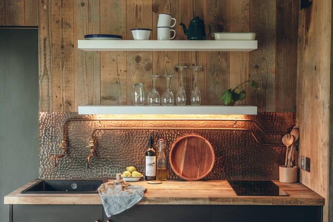 Kitchen equipped with induction hob, oven and cooking utensils