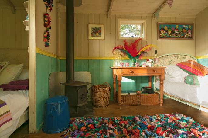 Snuggle up by the wood-burner in the colourful Lima hut in Gloucestershire