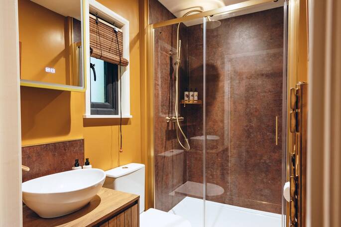Bathroom with a hot shower, sink and flushing toilet