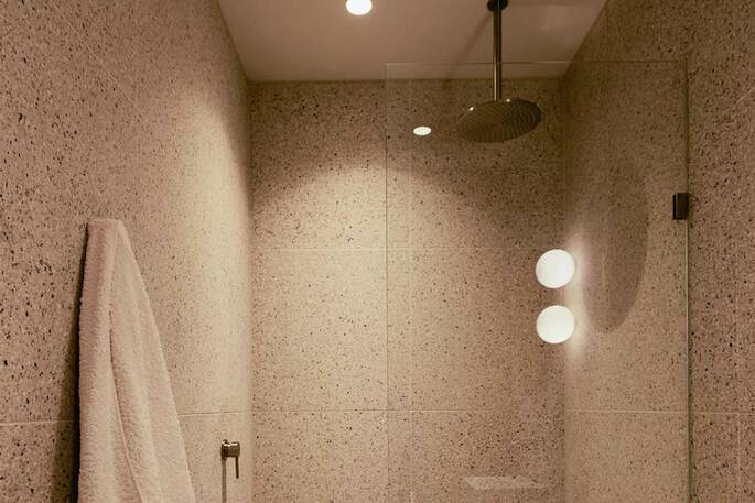 Bathroom with a hot shower, sink and flushing toilet