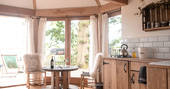 Look across the upcycled living space from the bed with views of Somerset beyond at Venn Treehouse