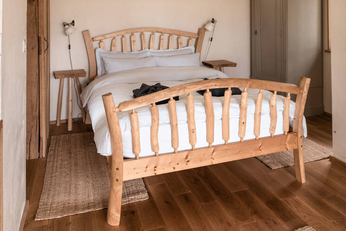 The quirky wood-crafted bed to lie with your morning coffee at Venn Treehouse in Herefordshire