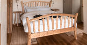 The quirky wood-crafted bed to lie with your morning coffee at Venn Treehouse in Herefordshire