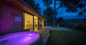 Willow Cabin hot tub at night, Clifford, Hereford, Herefordshire, England - by Alex Treadway