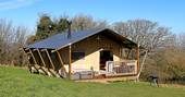 Sunny exterior shot of one of the safari tents at Drover's Rest in Herefordshire