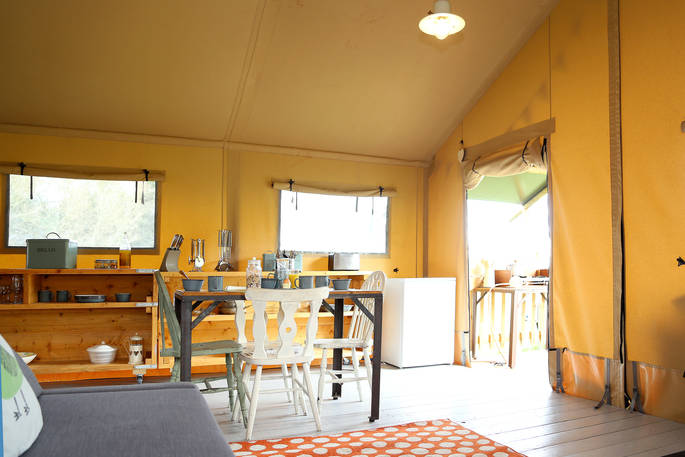 Dining and sofa area inside the safari tent at Drover’s Rest farm in Herefordshire
