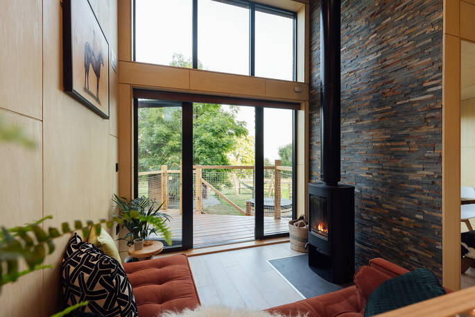 Bright and comfortable living area with a wood burner