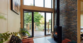 Bright and comfortable living area with a wood burner