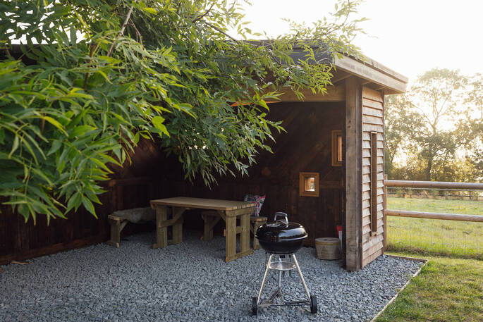 Outdoor BBQ area with a covered dining area