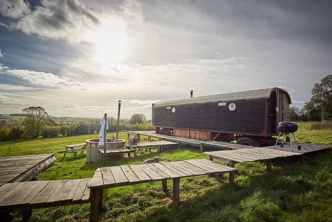 Front exterior shot of the wagon showing hot tub and landscape view