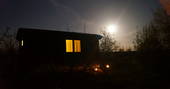 Woodland hut by moonlight
