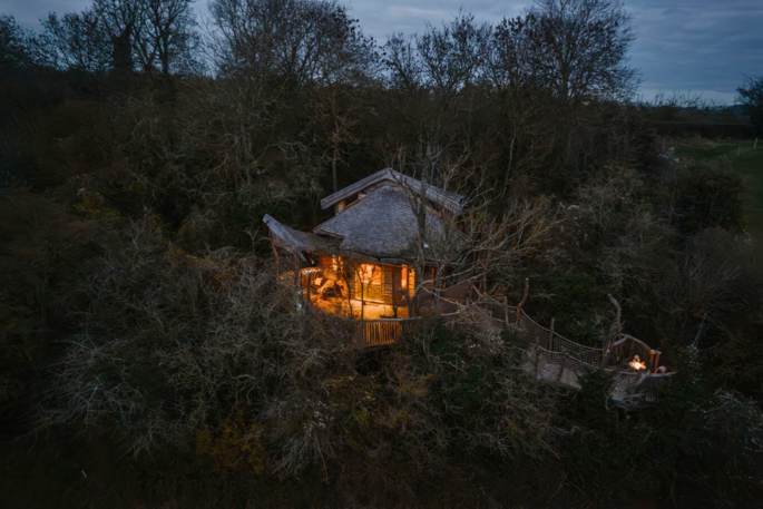 Exterior view of the treehouse in the evening