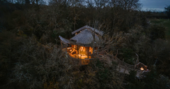 Exterior view of the treehouse in the evening