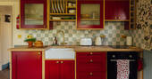Kitchen equipped with an oven, induction hob, kettle, toaster and cooking utensils, crockery and glassware