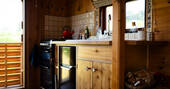 Kitchen wiht oven, undercounter fridge and stove