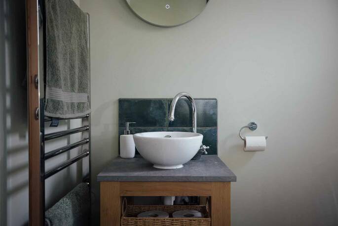 Bathroom with flushing toilet, shower and sink