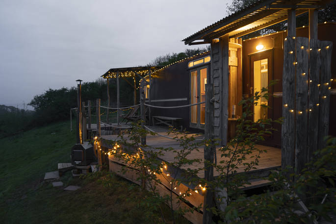 The Wagon Above the World during the night with fairy lights, glamping, Orcop, Herefordshire
