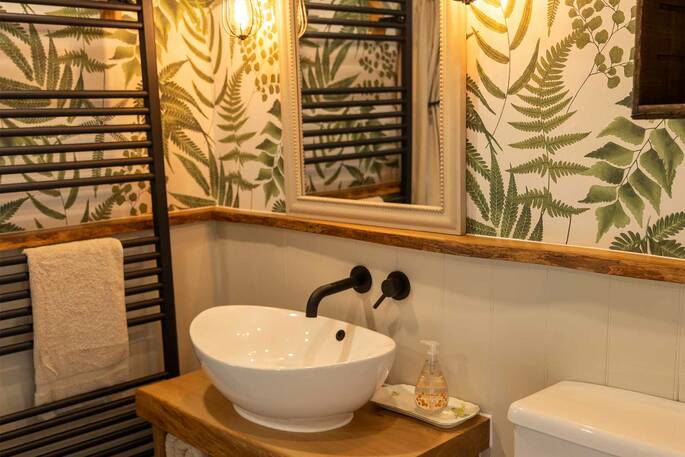 Bathroom witha  flushing toilet, sink and hot shower