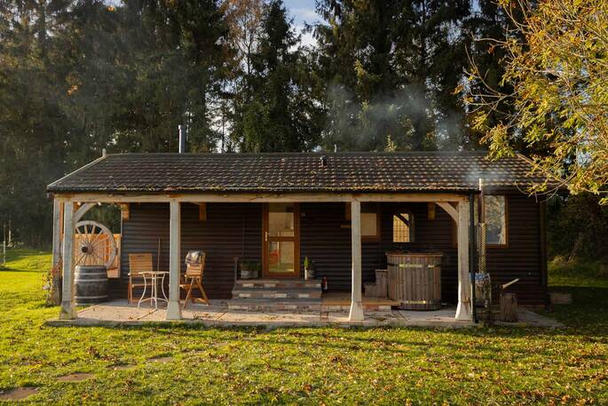 Front exterior showing hot tub and outdoor seating