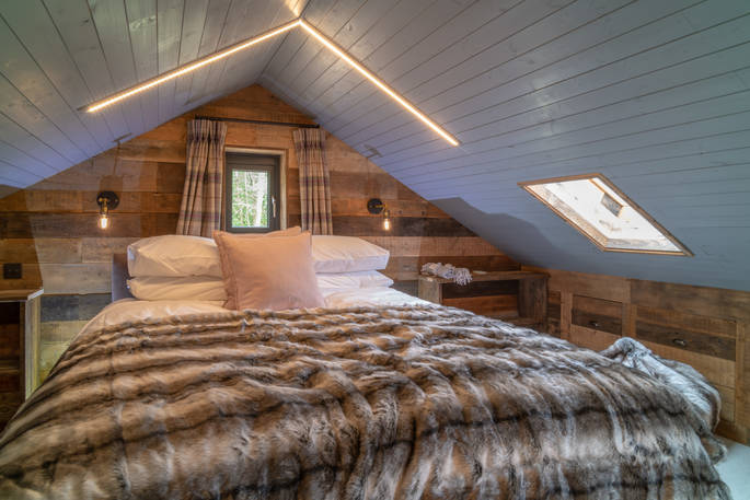 One of three double beds inside Knotting Hill Barn House in Leicestershire 