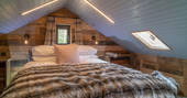 One of three double beds inside Knotting Hill Barn House in Leicestershire 
