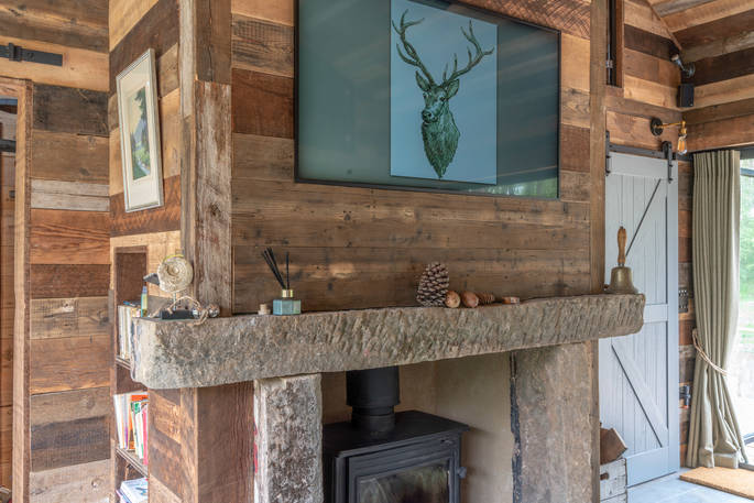 Wood-burner and mantel piece inside Knotting Hill Barn House 